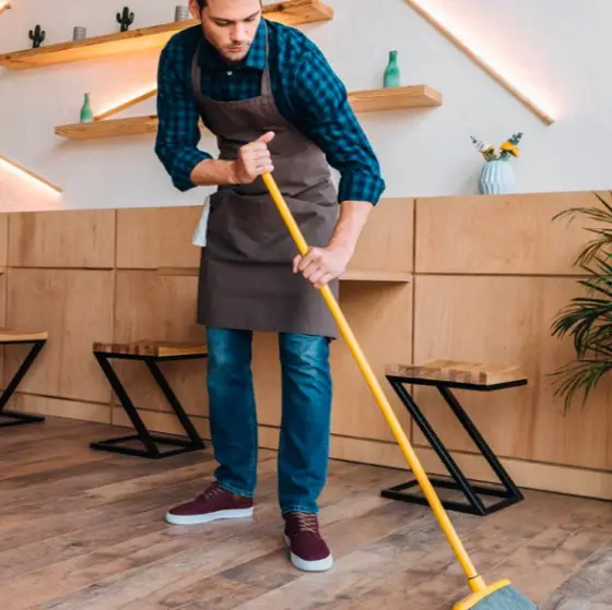 Man cleaning hardwood | Jubilee Flooring & Decorating