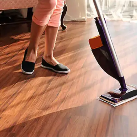 Lady cleaning laminate floor | Jubilee Flooring & Decorating